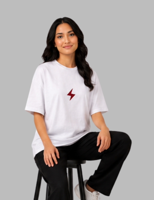 Woman wearing a white t-shirt with a red lightning bolt design on a gray background