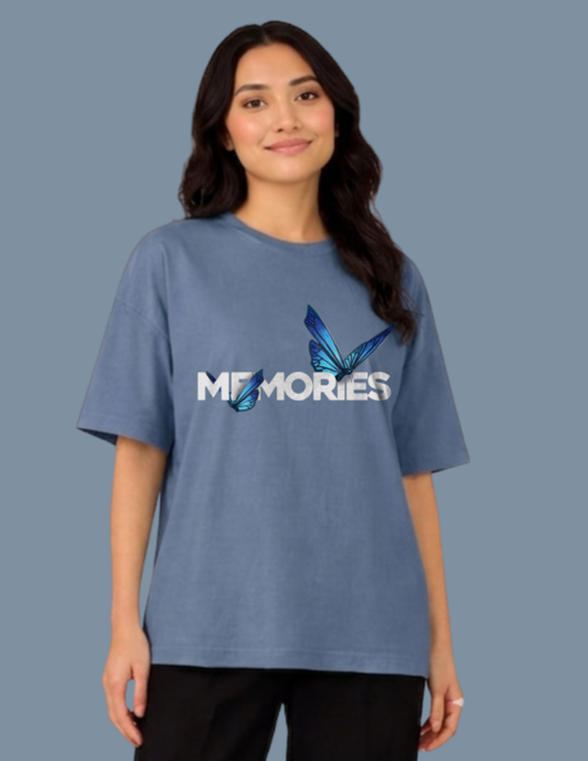Person wearing a blue t-shirt with 'MEMORIES' design on a plain background