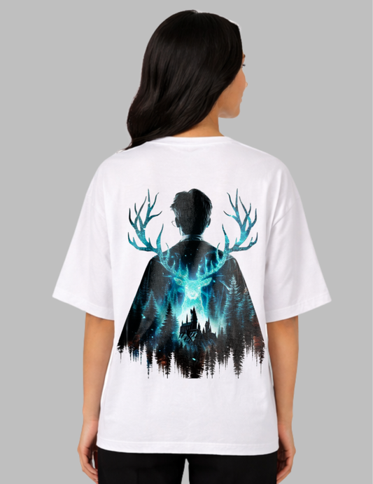 Person wearing a white t-shirt with a graphic design on the back, featuring a silhouette of a person with deer antlers and a forest.