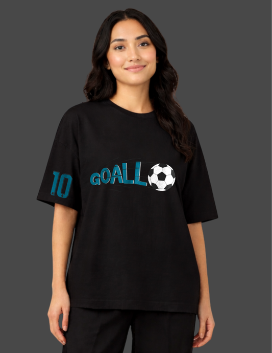 Person wearing a black t-shirt with 'GOALL' and a soccer ball graphic on a dark background