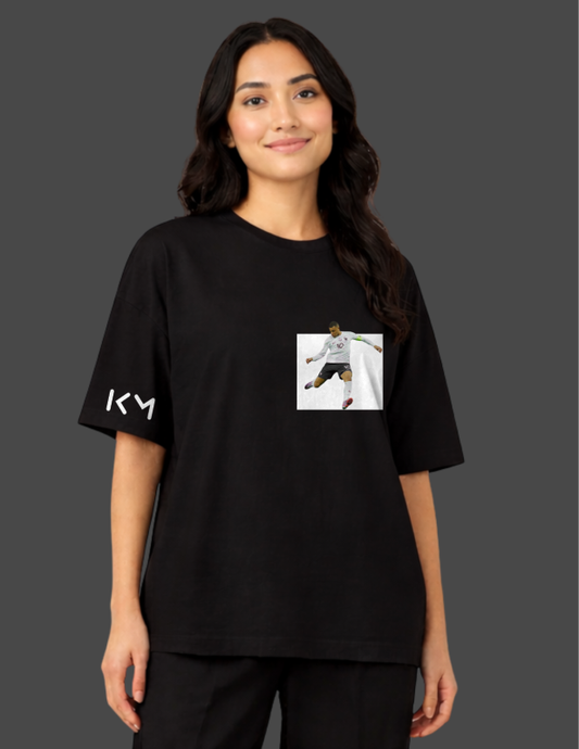 Person wearing a black t-shirt with a logo and image on a dark background