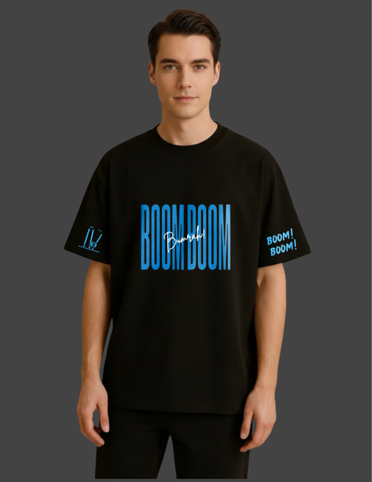 Person wearing a black t-shirt with 'BOOM BOOM' text and graphics on a dark background