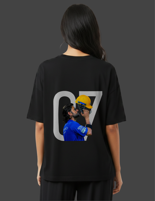 Person wearing a black t-shirt with a graphic design on the back, featuring a person in a blue shirt and yellow helmet.