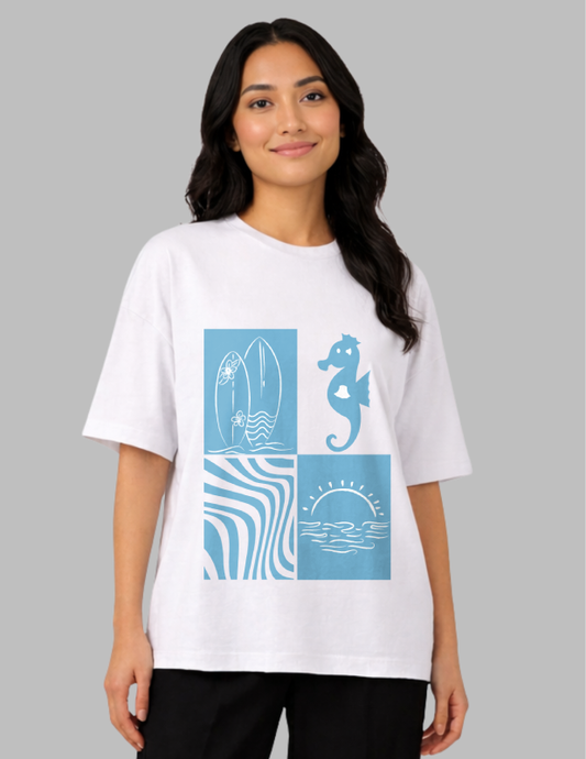 Woman wearing a white t-shirt with blue ocean-themed graphics on a gray background