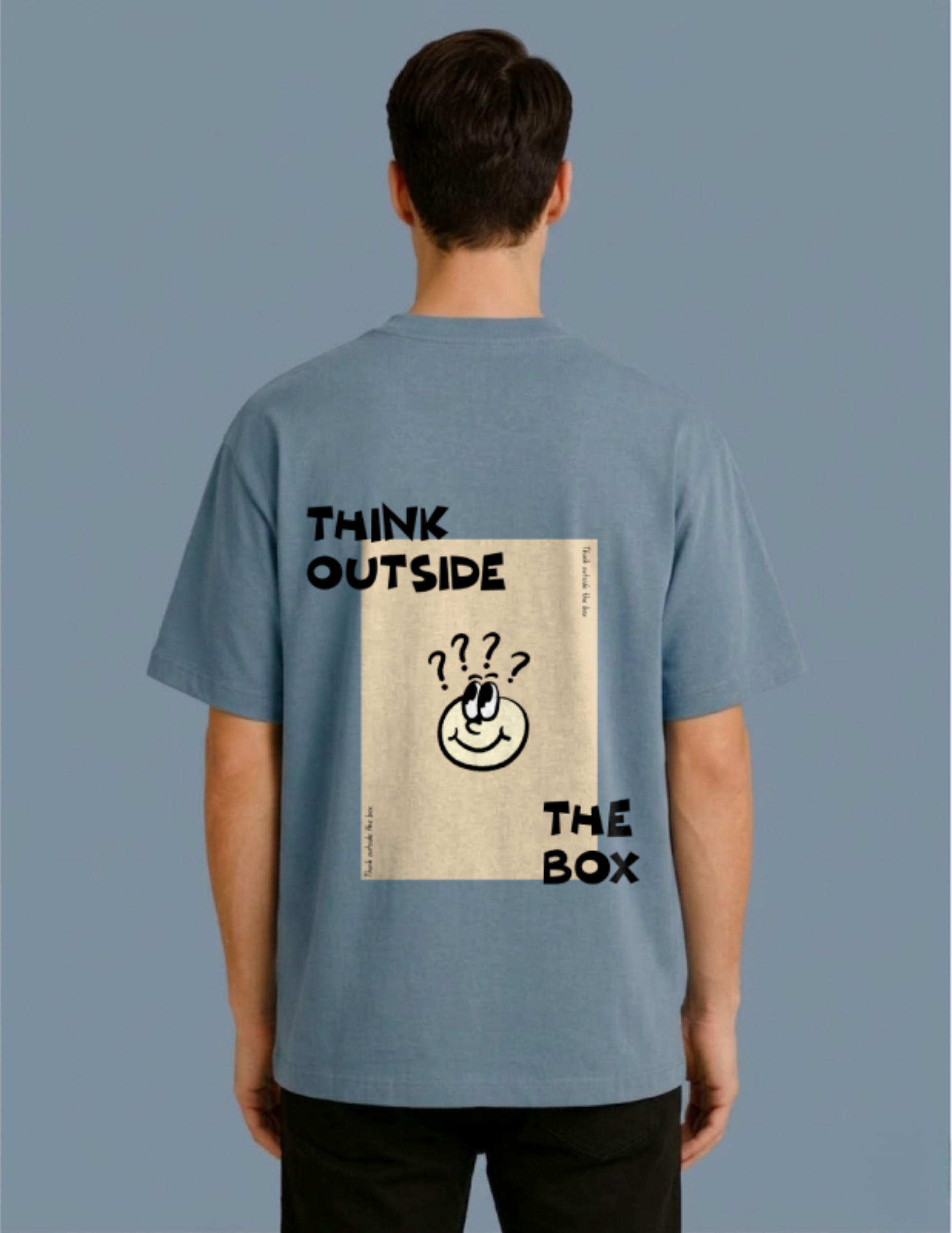 Person wearing a blue t-shirt with 'Think Outside The Box' text and graphic on the back against a gray background