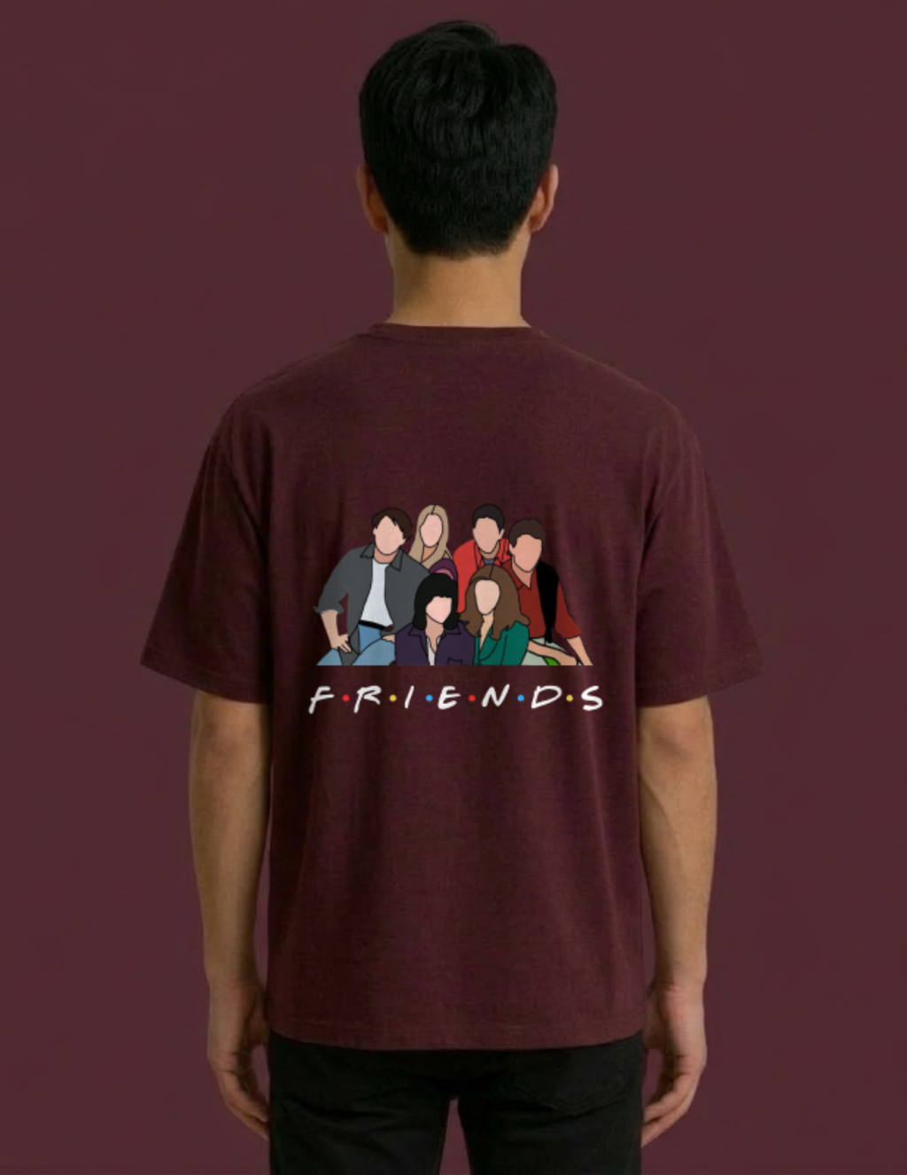 Person wearing a maroon 'Friends' t-shirt with character illustration on the back against a dark background