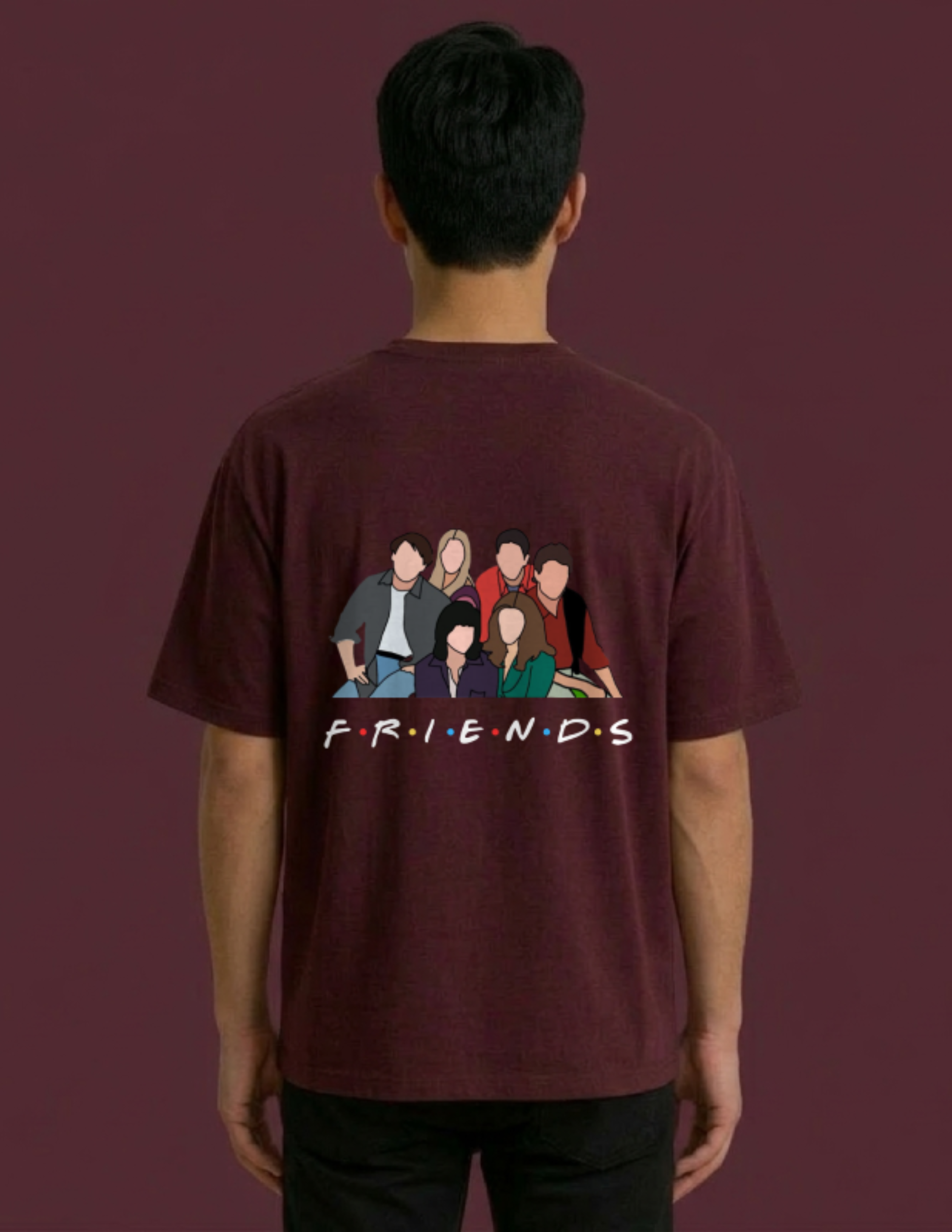 Person wearing a maroon 'Friends' t-shirt with character illustration on the back against a dark background