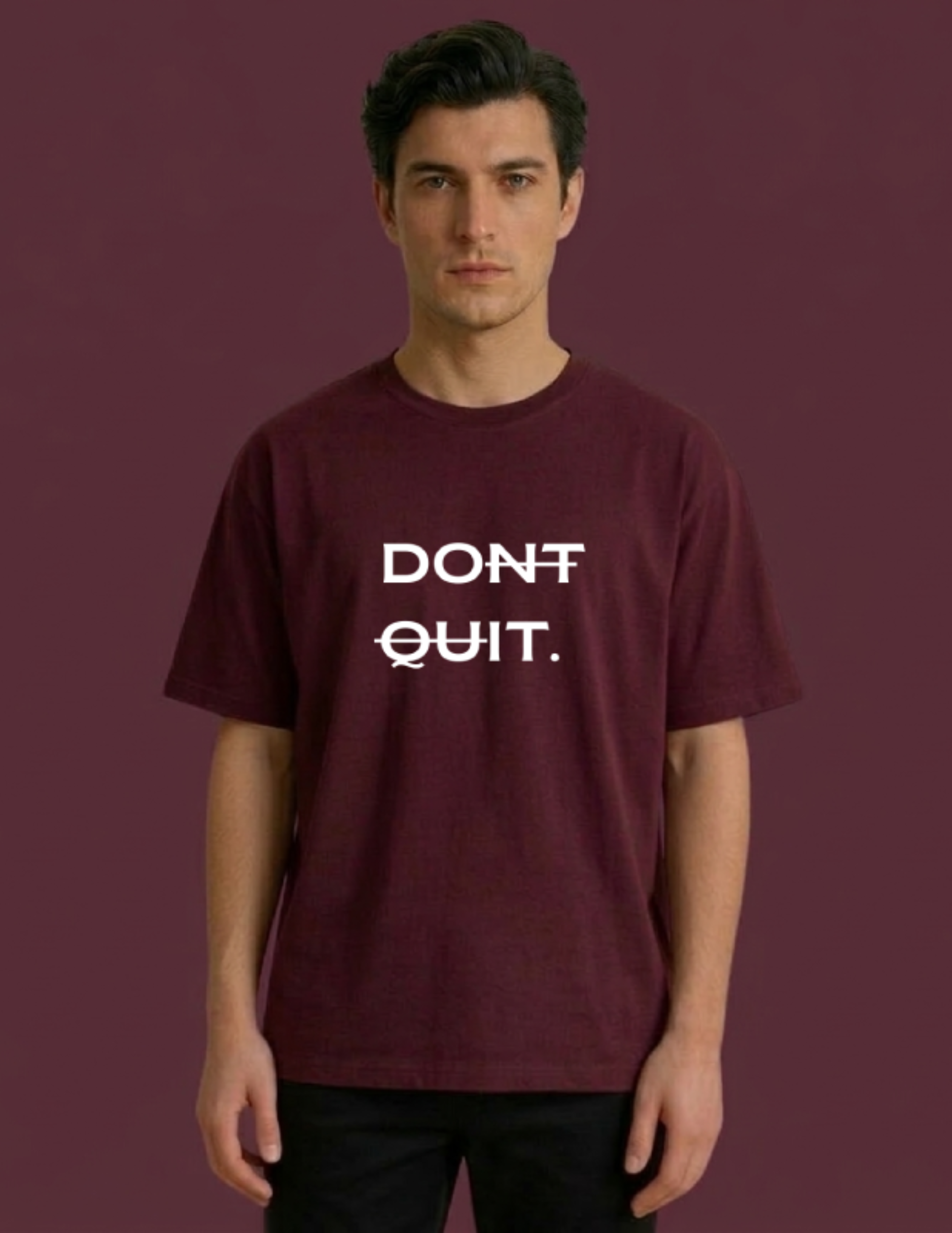 Man wearing a maroon t-shirt with 'DON'T QUIT.' text on a purple background