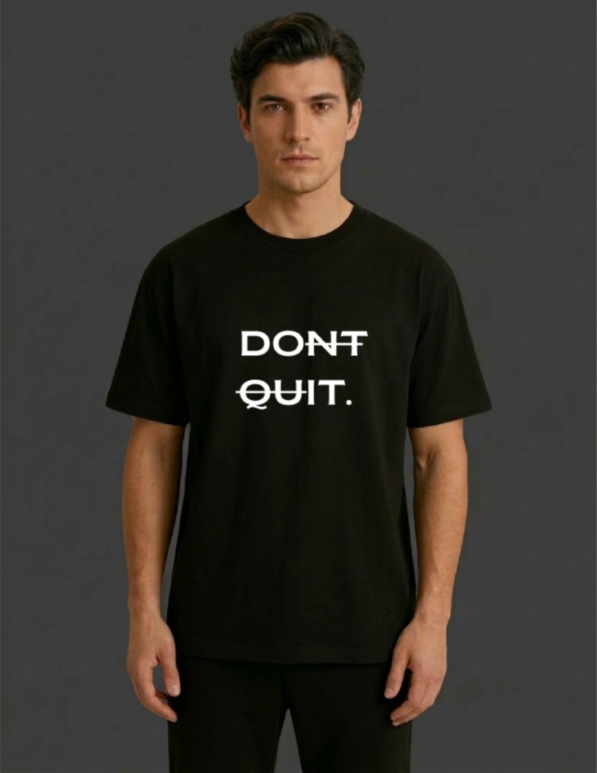 Man wearing a black t-shirt with 'DON'T QUIT.' text on a dark background