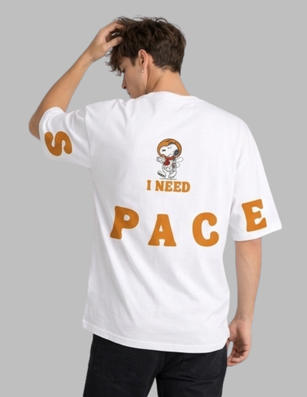 Person wearing a white t-shirt with a cartoon character and text on a gray background