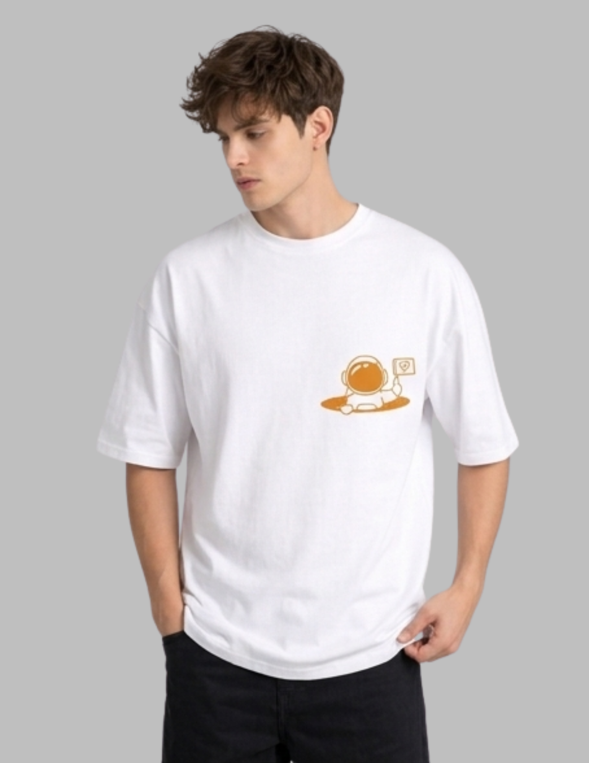Person wearing a white t-shirt with a small graphic on a gray background