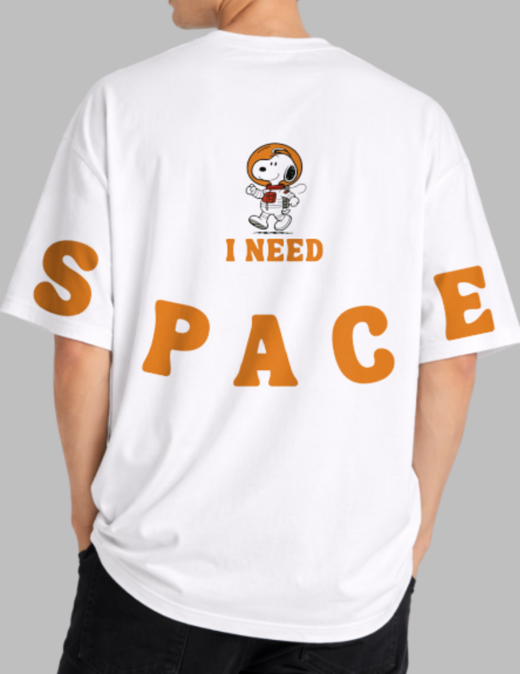 White t-shirt with a cartoon dog and 'I Need Space' text on the back, worn by a person.