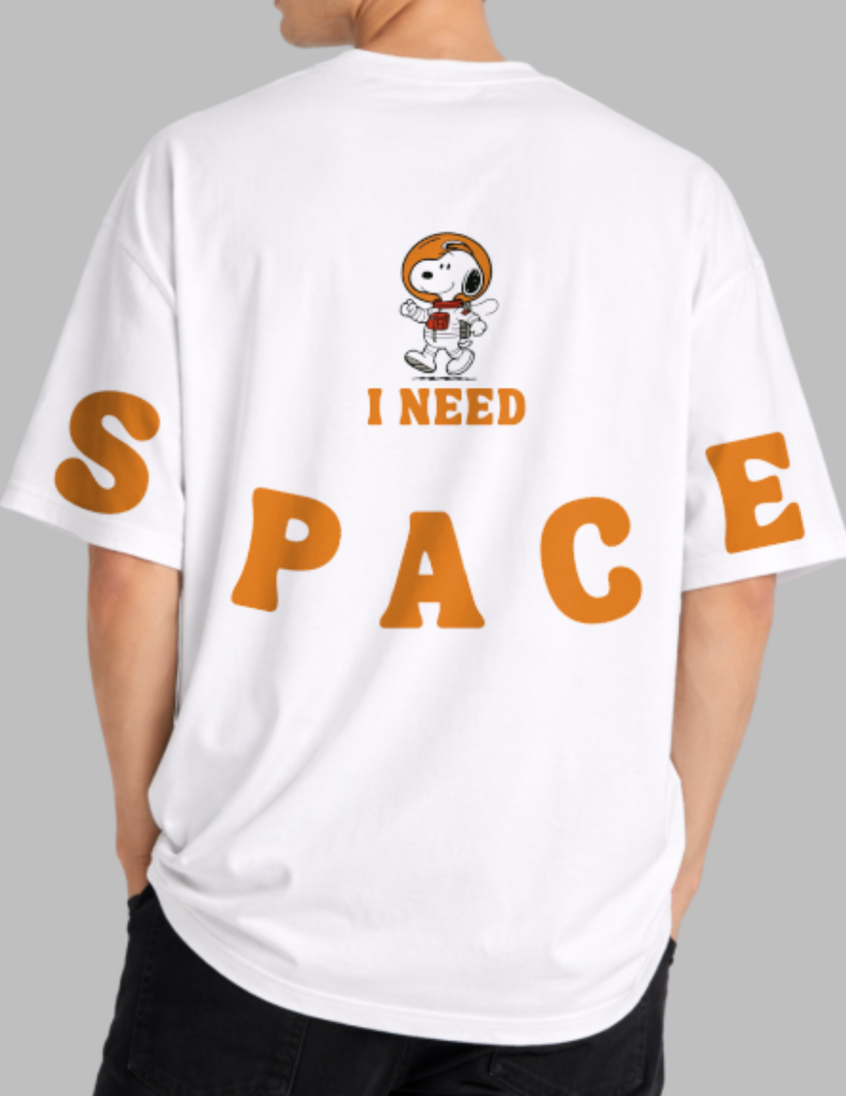 White t-shirt with a cartoon dog and 'I Need Space' text on the back, worn by a person.