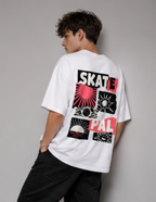 A man wearing a white t-shirt with a large graphic print on the back, featuring the words 'SKATE' and 'PAL' in black and red with sunburst and geometric designs, posed against a neutral gray background.