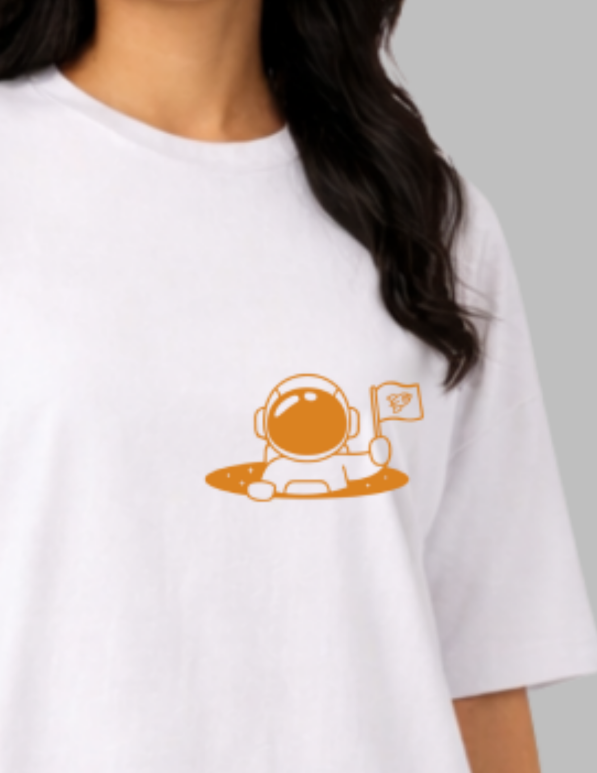White t-shirt with an orange astronaut graphic on a gray background