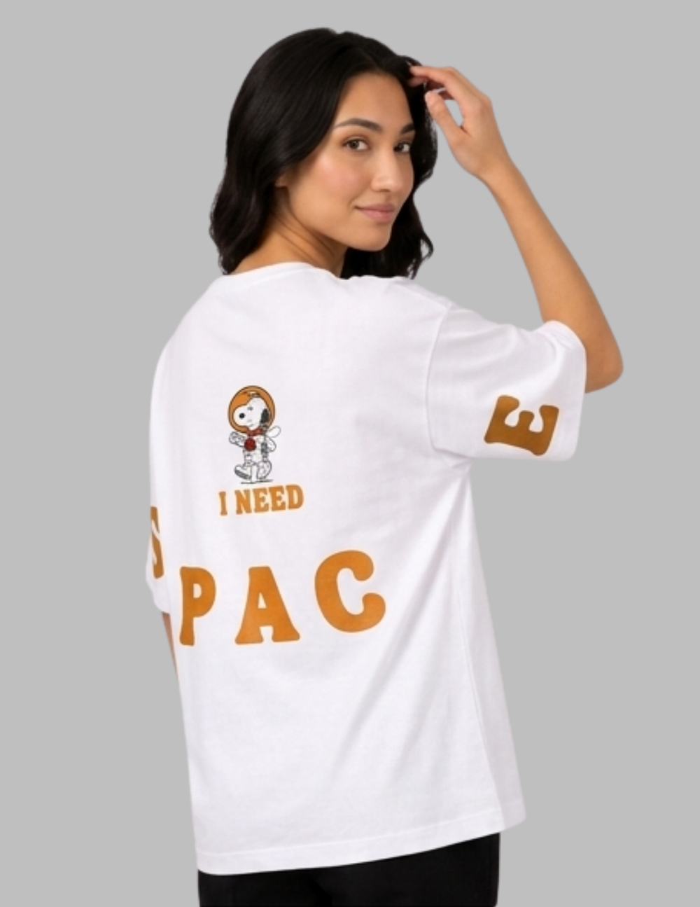 Woman wearing a white t-shirt with text and graphics on a gray background