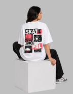 A model sitting on a white block, viewed from the back, wearing a white t-shirt with a large red, black, and white graphic print that reads 'SKATE PAL'.