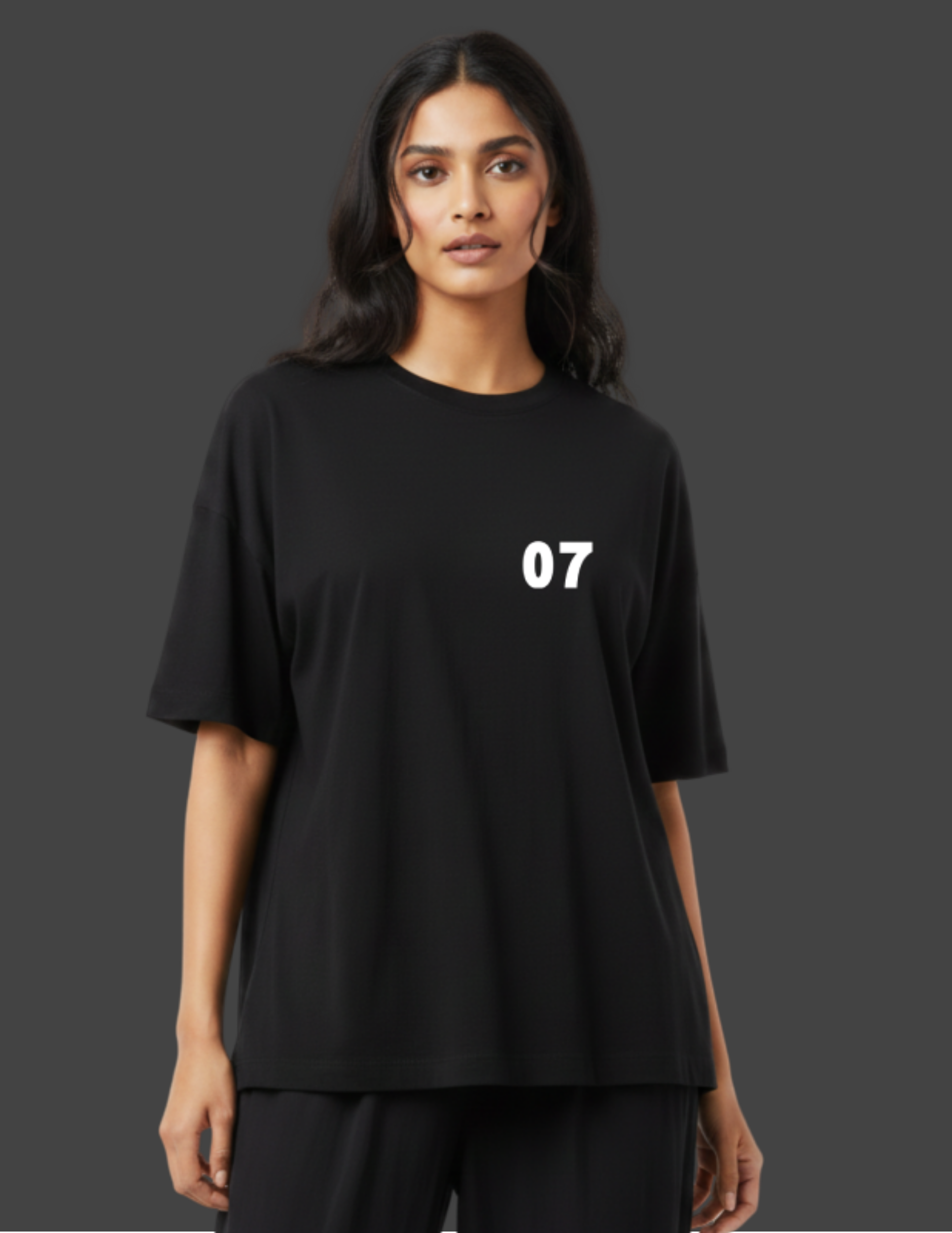 Person wearing a black t-shirt with the number 07 on a dark background