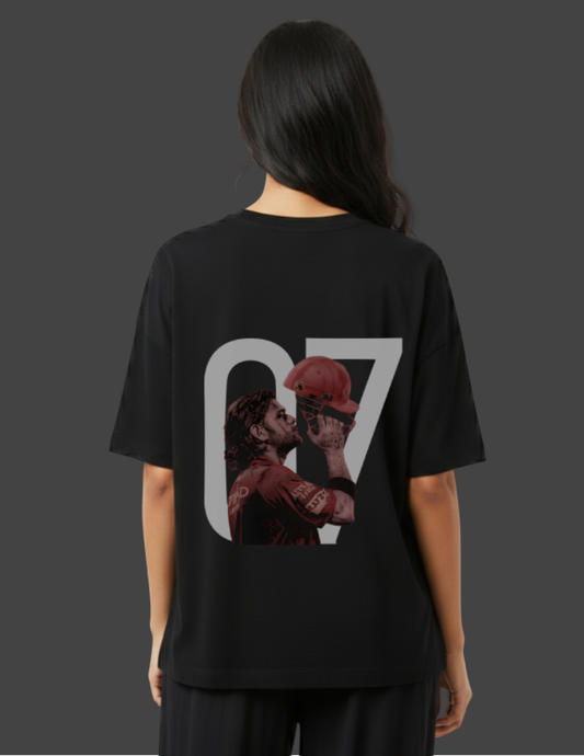 Person wearing a black t-shirt with a graphic design on the back