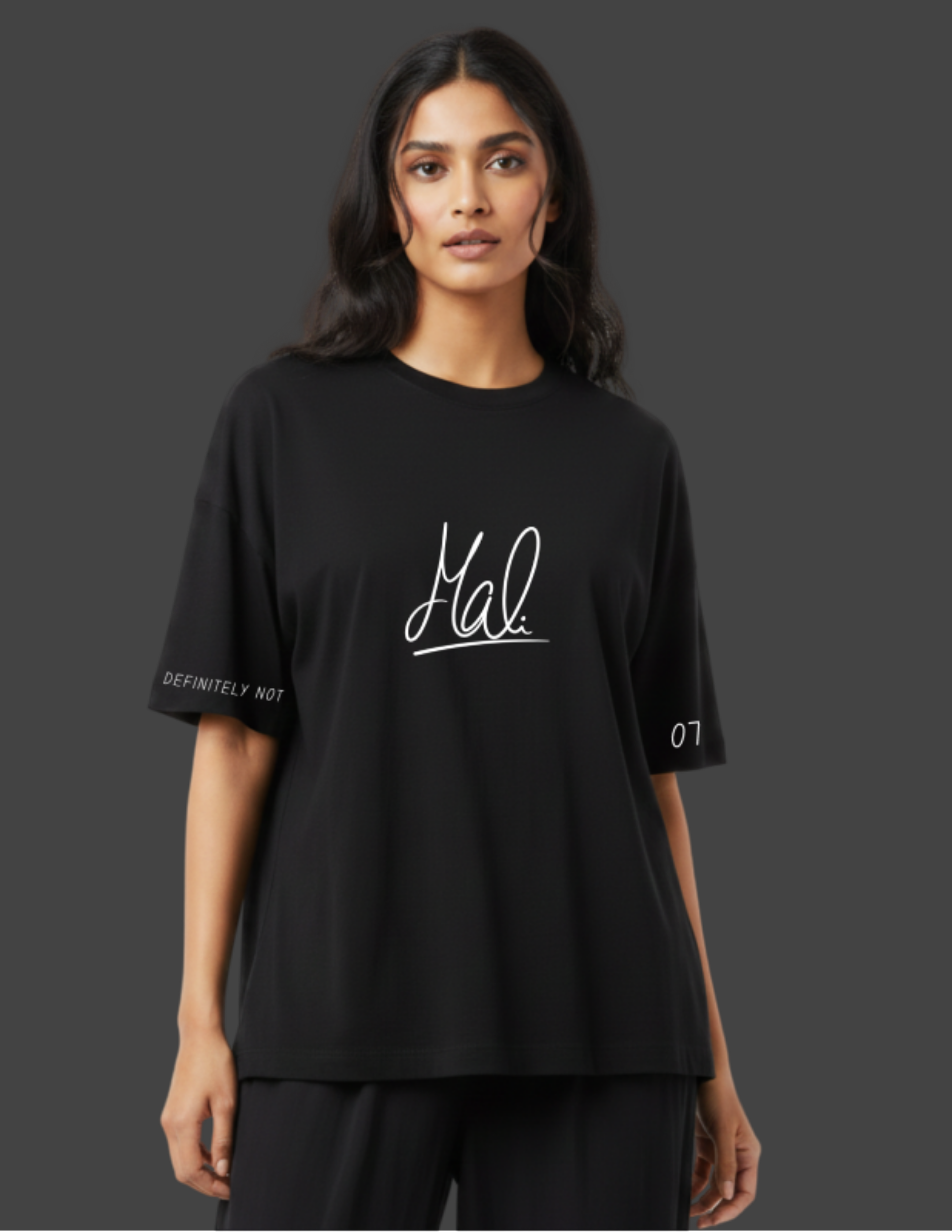 Person wearing a black t-shirt with 'Mal' logo on a dark background