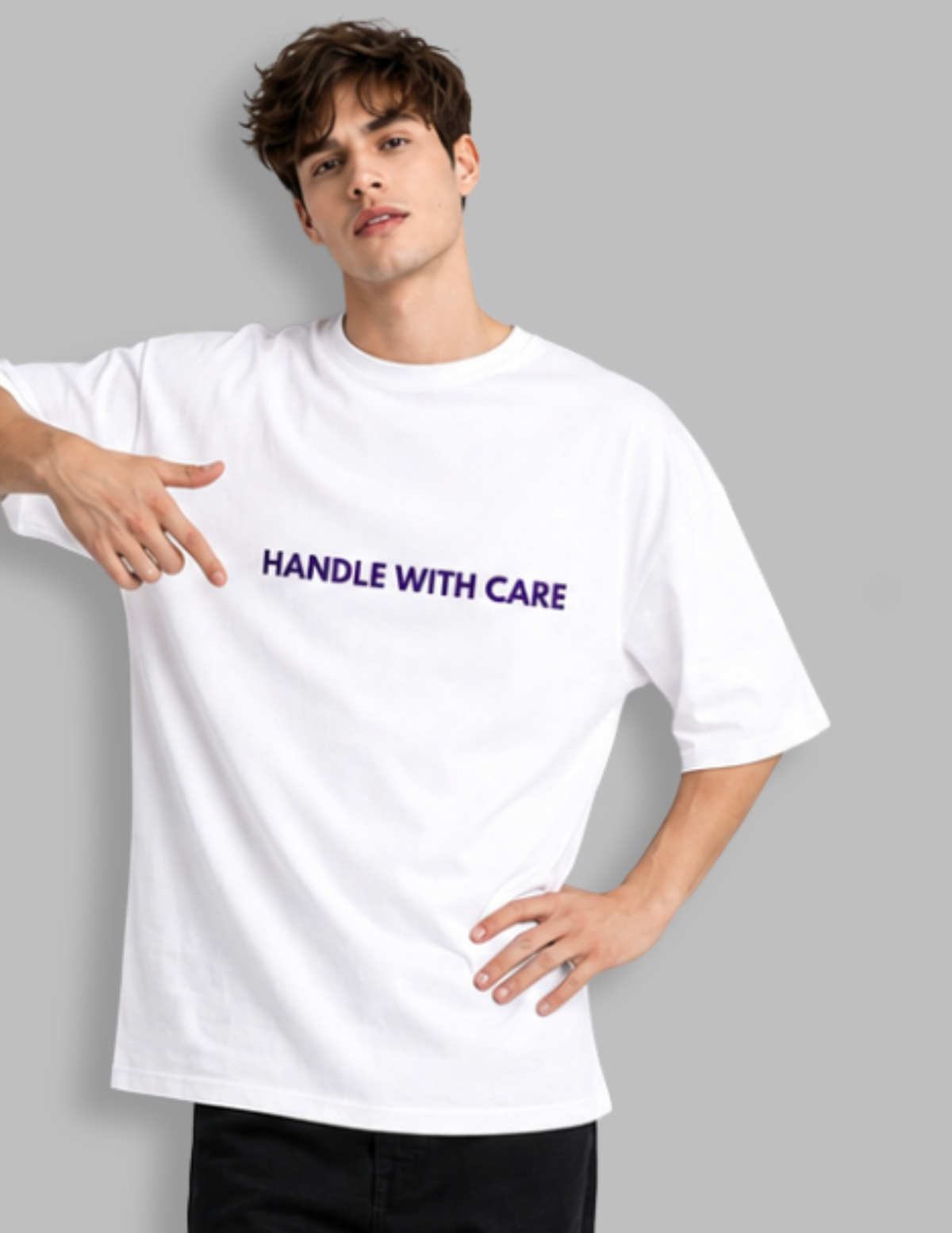 Person wearing a white t-shirt with 'HANDLE WITH CARE' text in purple on a gray background