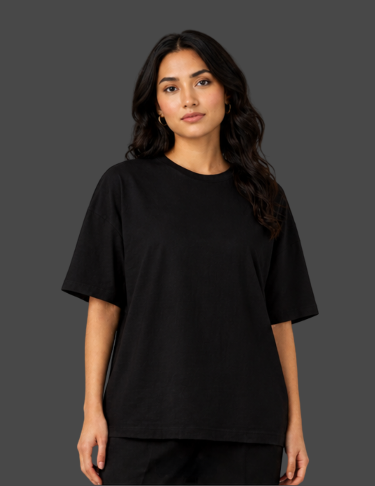 A woman modeling a plain black short-sleeve crewneck t-shirt against a solid dark gray studio background.