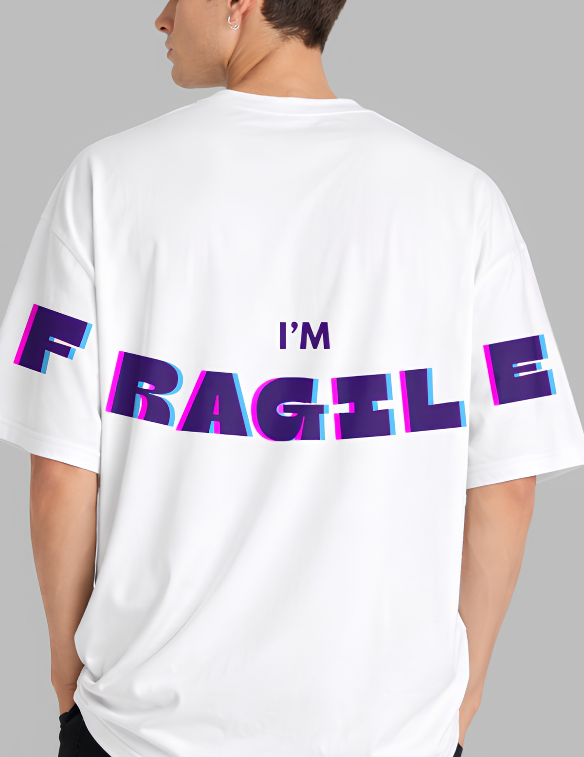 Person wearing a white t-shirt with 'I'm Fragile' text in colorful letters on the back.