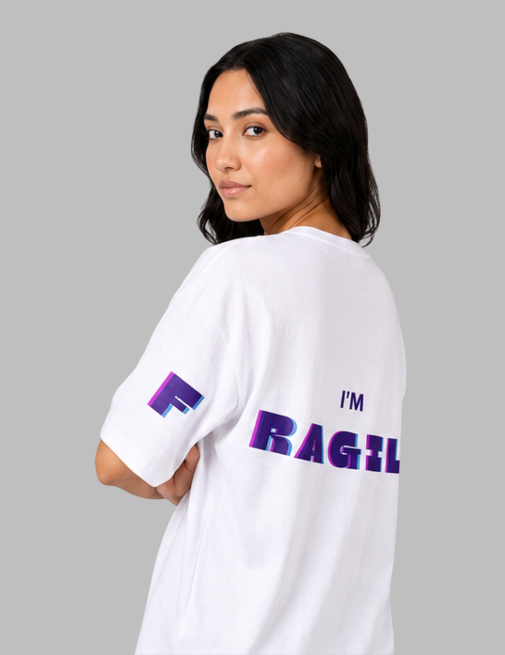 Person wearing a white t-shirt with 'I'm Fragile' text on a gray background