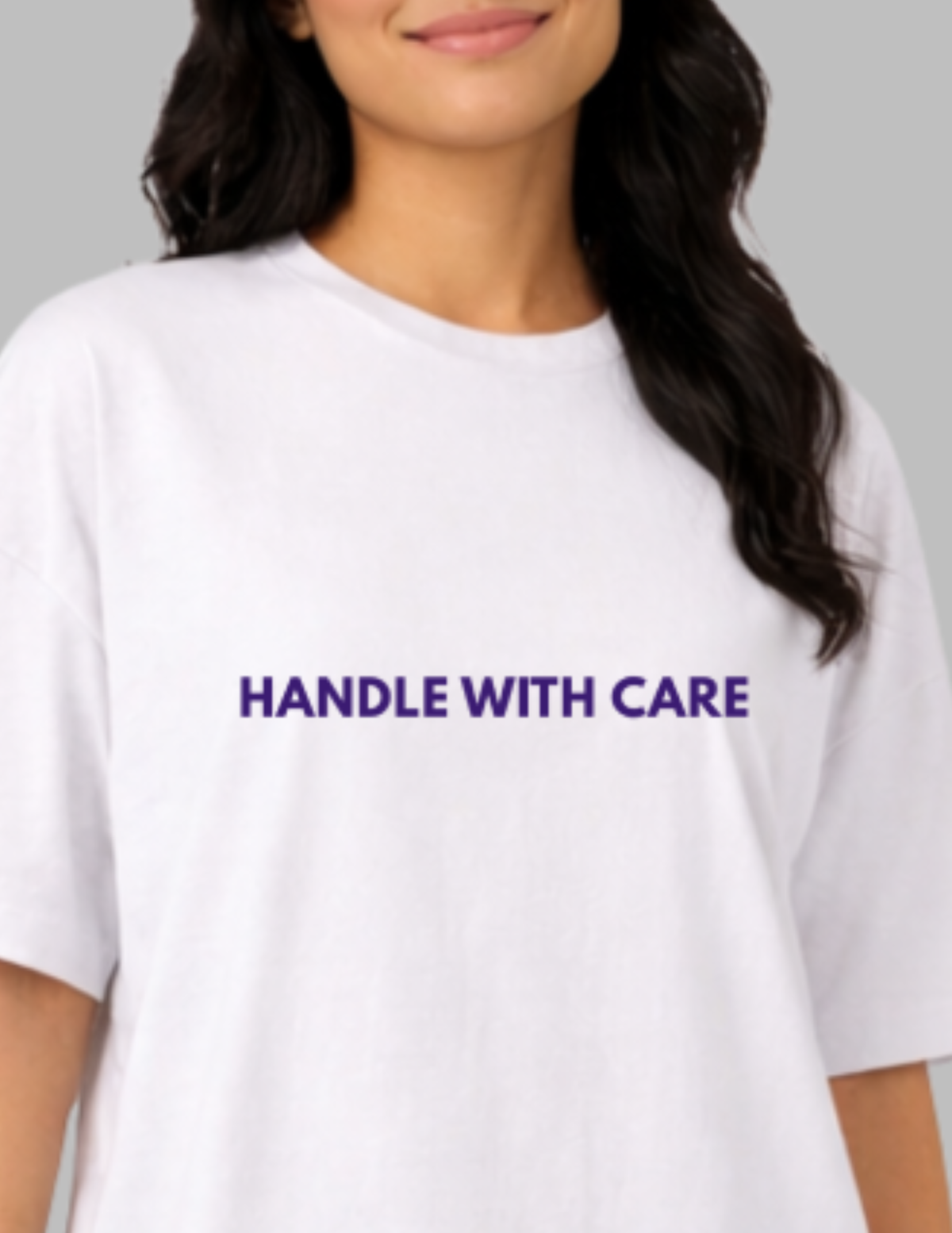 White t-shirt with 'HANDLE WITH CARE' text on a plain background