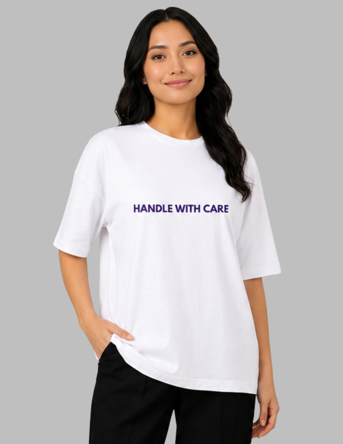 Woman wearing a white t-shirt with 'HANDLE WITH CARE' text on a gray background