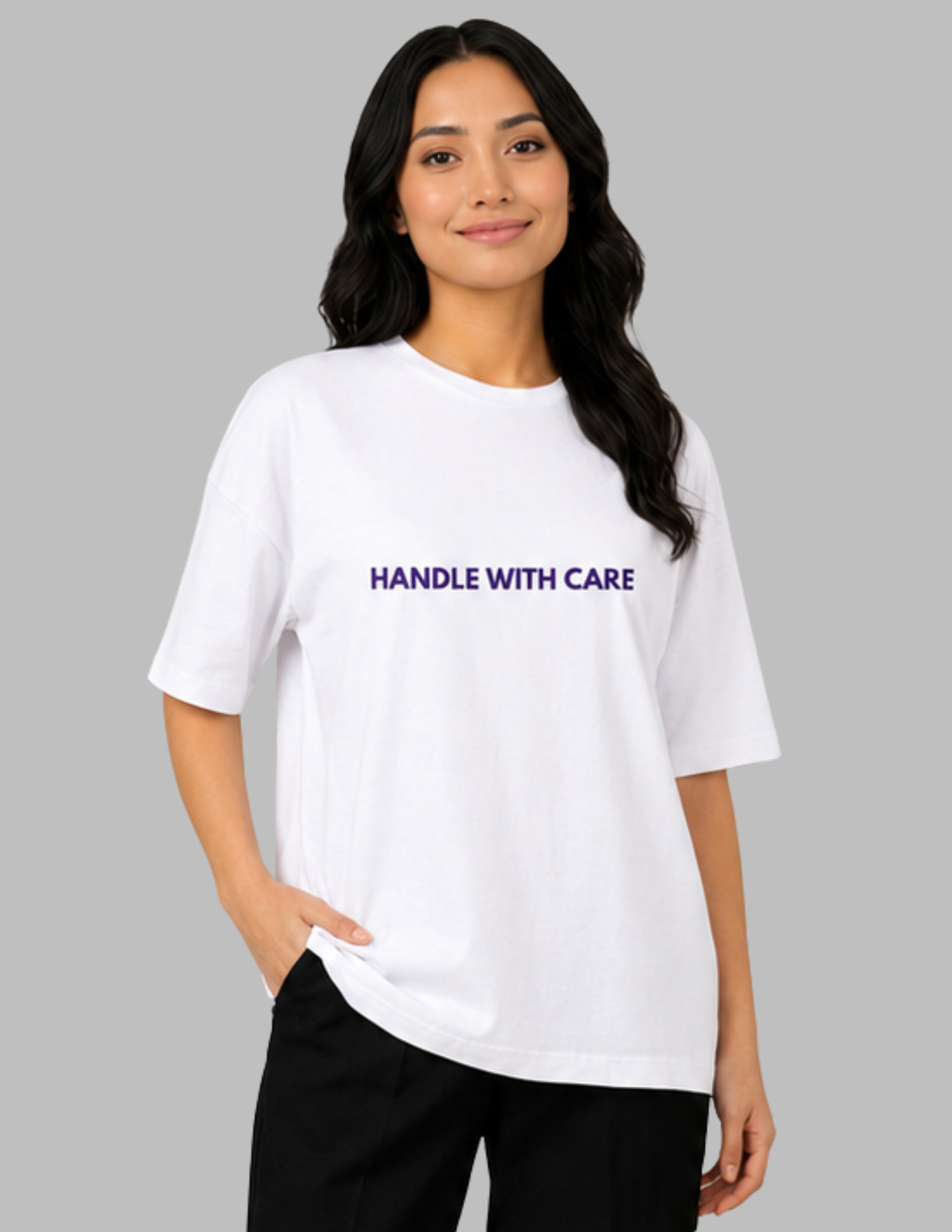 Woman wearing a white t-shirt with 'HANDLE WITH CARE' text on a gray background