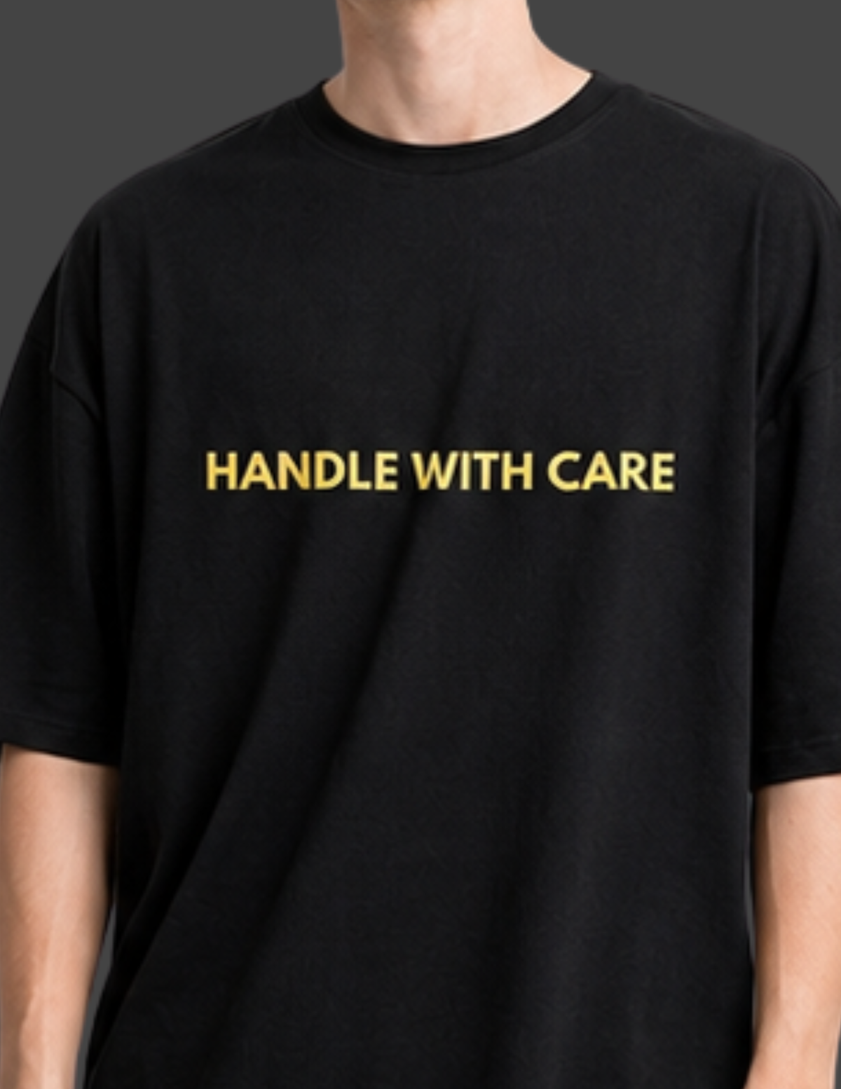 Black t-shirt with 'HANDLE WITH CARE' text in gold on a plain background