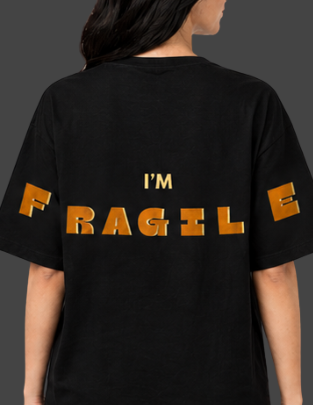 Black t-shirt with 'I'm Fragile' text in gold on a plain background