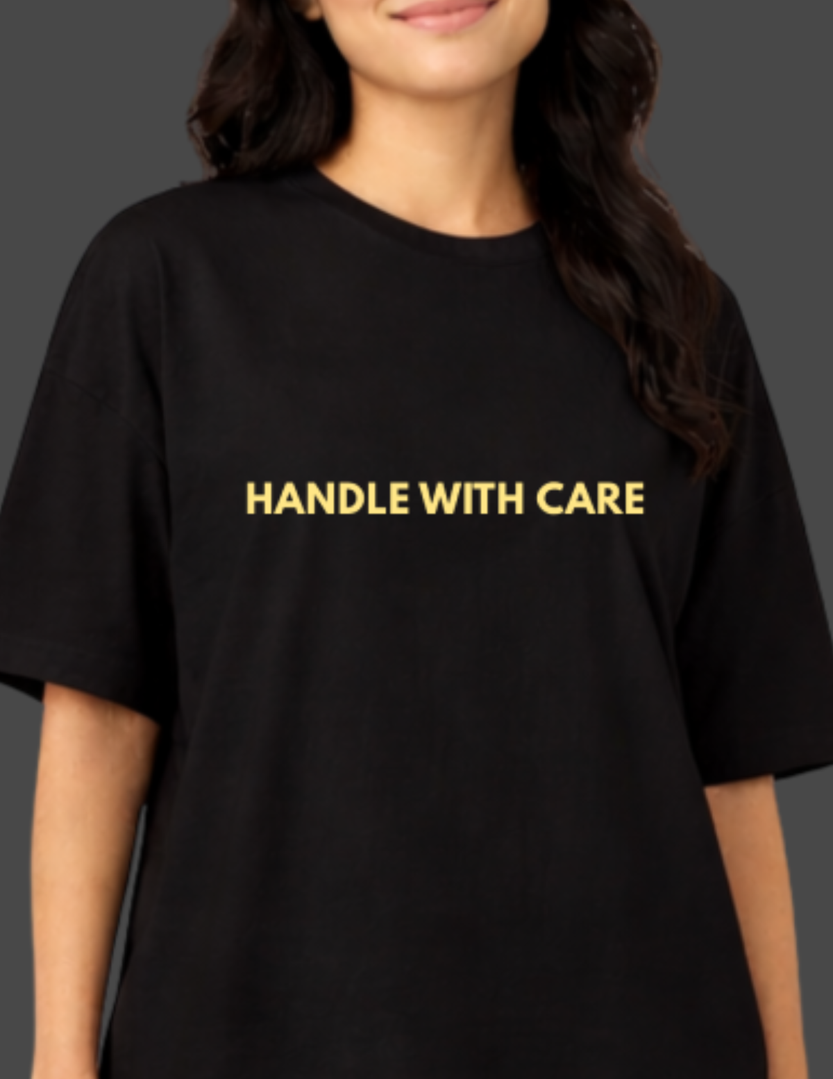 Person wearing a black t-shirt with 'HANDLE WITH CARE' text in yellow.