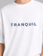 White t-shirt with 'TRANQUIL' text on a plain background