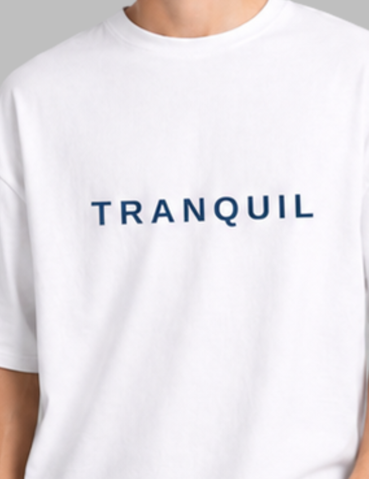 White t-shirt with 'TRANQUIL' text on a plain background