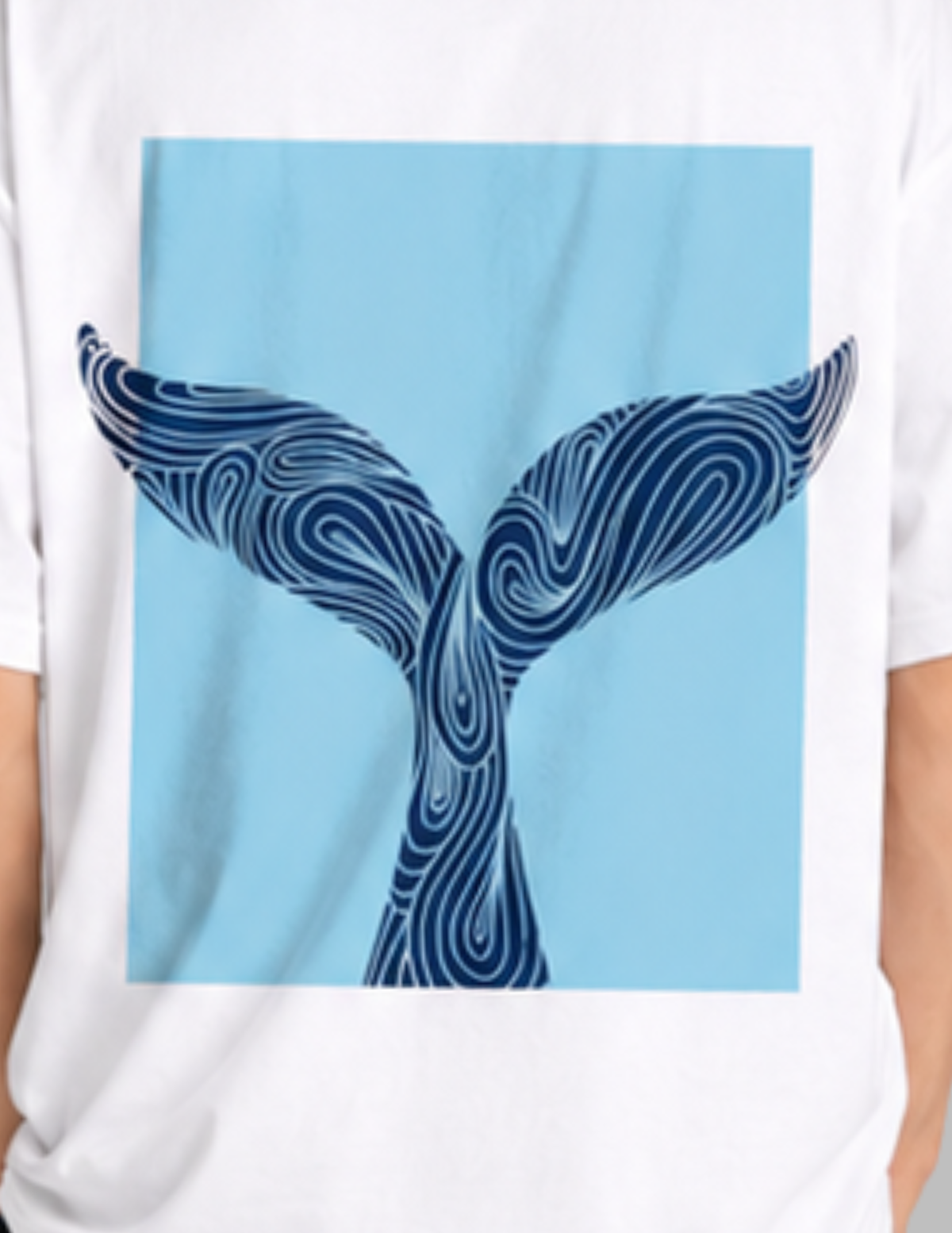 White t-shirt with a blue whale tail design on a light blue background