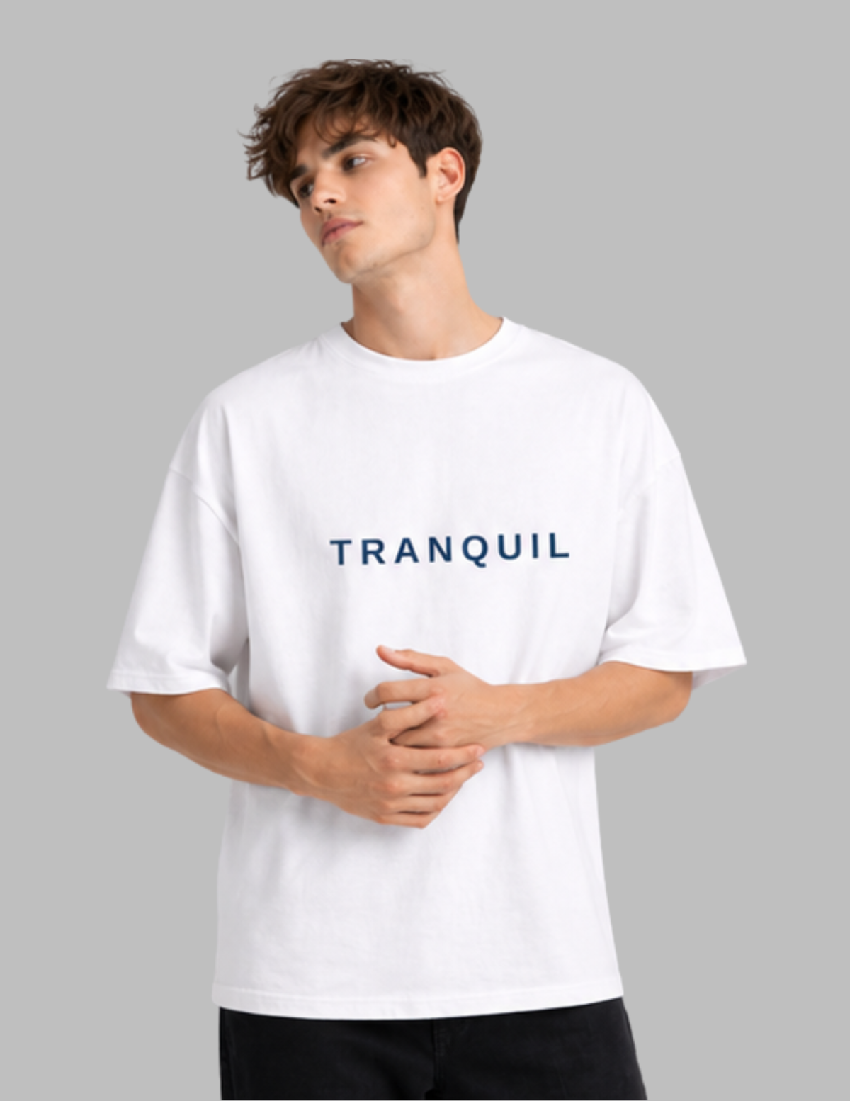 Person wearing a white t-shirt with 'TRANQUIL' text on a gray background