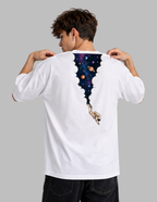 A man viewed from behind wearing a white t-shirt with a graphic print of a space-themed void opening down his back, revealing a colorful galaxy and an astronaut. He is posing to show the back of the shirt against a solid gray background.