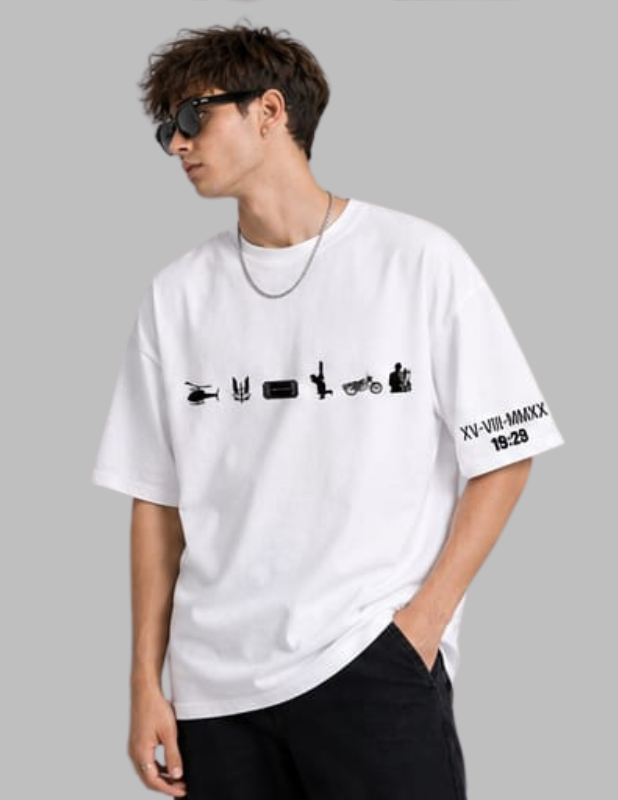 A man wearing a white oversized graphic t-shirt with black printed icons and Roman numerals on the sleeve, paired with black pants, set against a solid gray background.