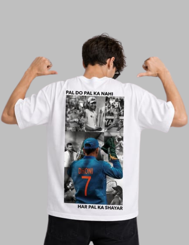 A man shown from behind wearing a white t-shirt with a large graphic print on the back featuring cricket player Virat Kohli and Hindi text, posing with his arms flexed against a solid gray background.
