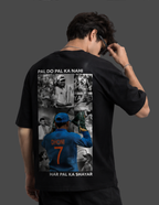 A man shown from behind wearing a black t-shirt with a large graphic print on the back. The print features a collage of images, including a blue jersey with the name 'DHONI' and number '7', along with white text reading 'PAL DO PAL KA NAHI' at the top and 'HAR PAL KA SHAYAR' at the bottom.