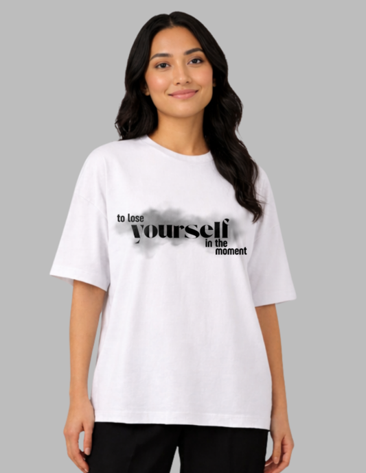 Woman wearing a white t-shirt with text on a gray background