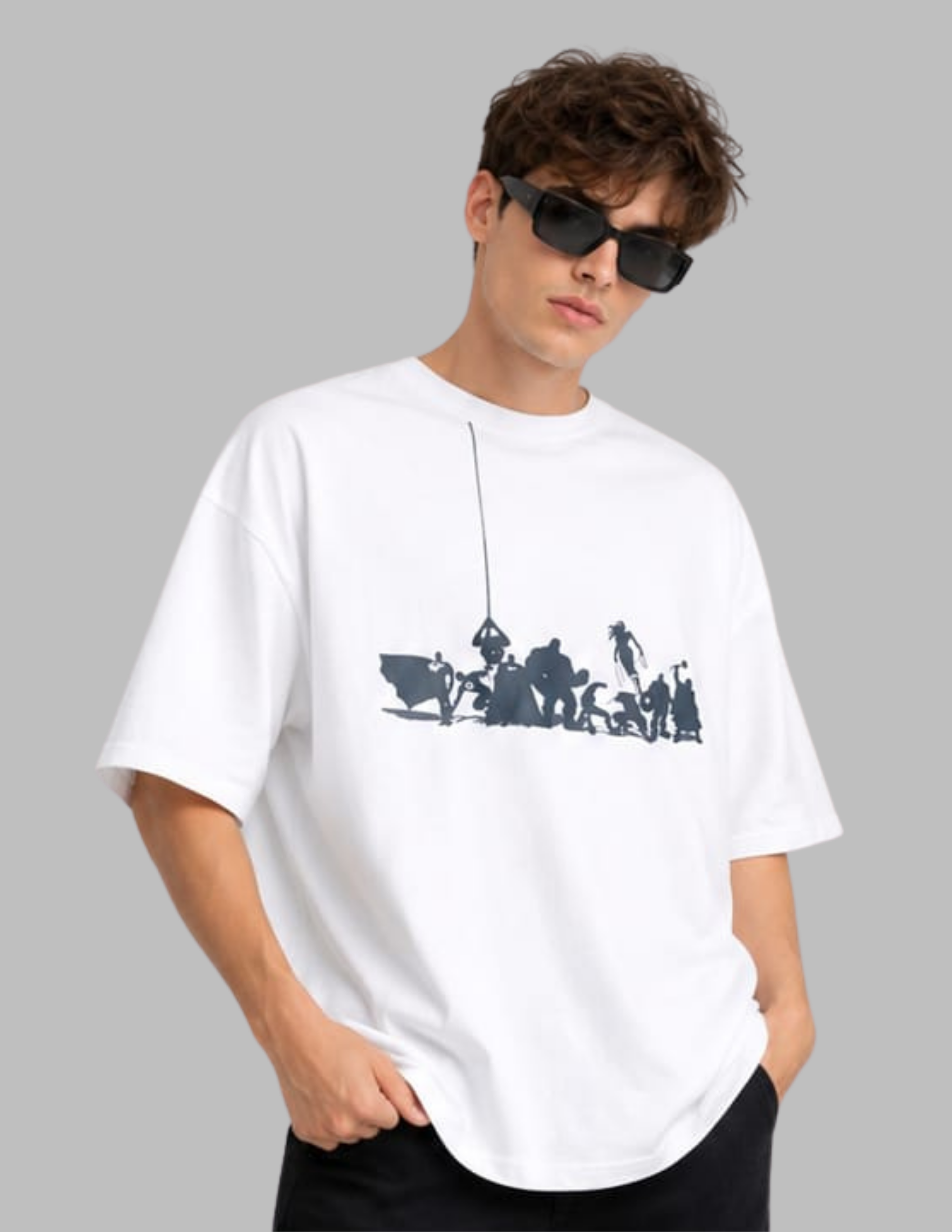 A man wearing an oversized white t-shirt with a dark navy blue graphic print of figures on a rope, styled with black sunglasses and black pants against a solid gray background.