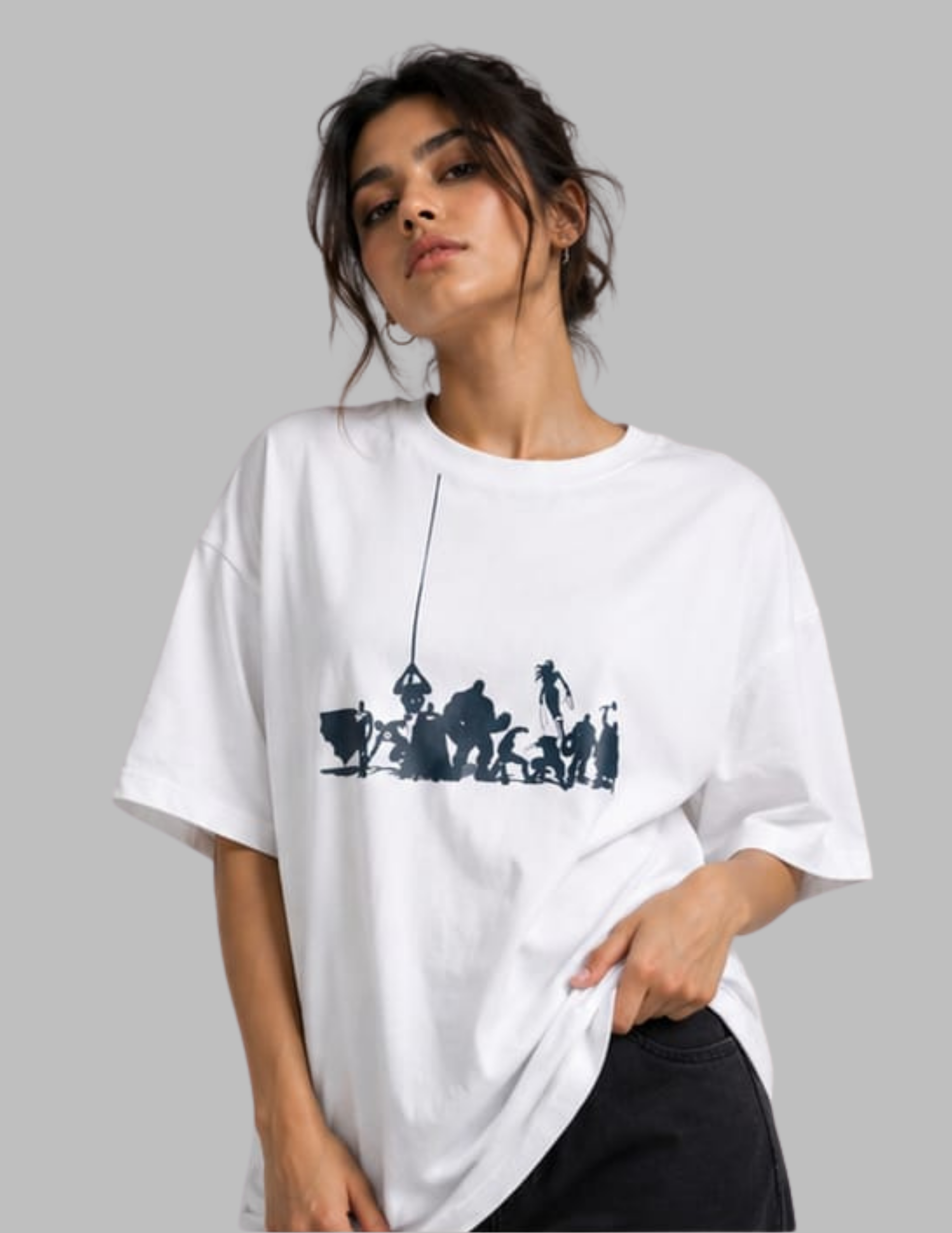 A woman wearing an oversized white t-shirt with a black graphic print of a hanging figure, posed against a solid gray background.