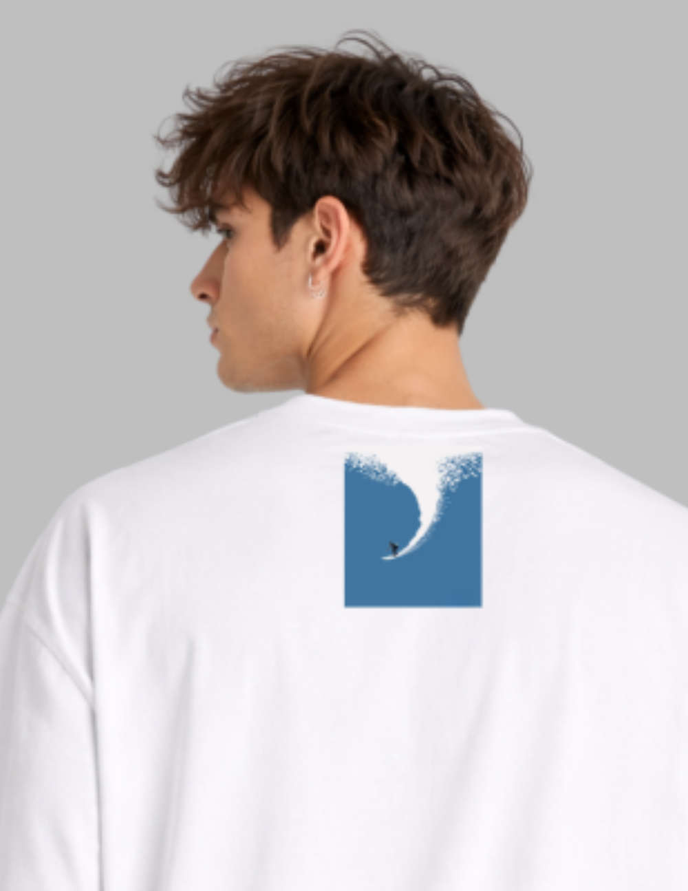 Person wearing a white long-sleeve shirt with a blue wave design on the back against a gray background