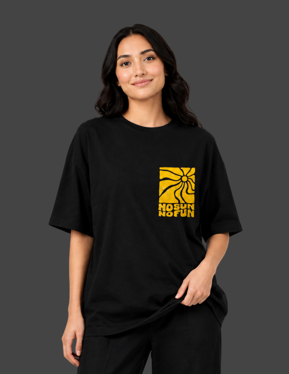 Person wearing a black t-shirt with a yellow logo and text on a dark background