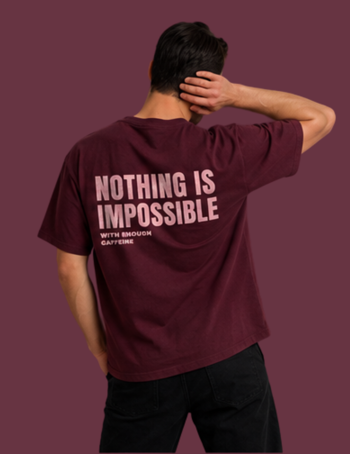 A man shown from the back wearing a maroon t-shirt with the text 'NOTHING IS IMPOSSIBLE WITH ENOUGH CAPEFERIE' printed in light pink on the back, set against a solid maroon background.