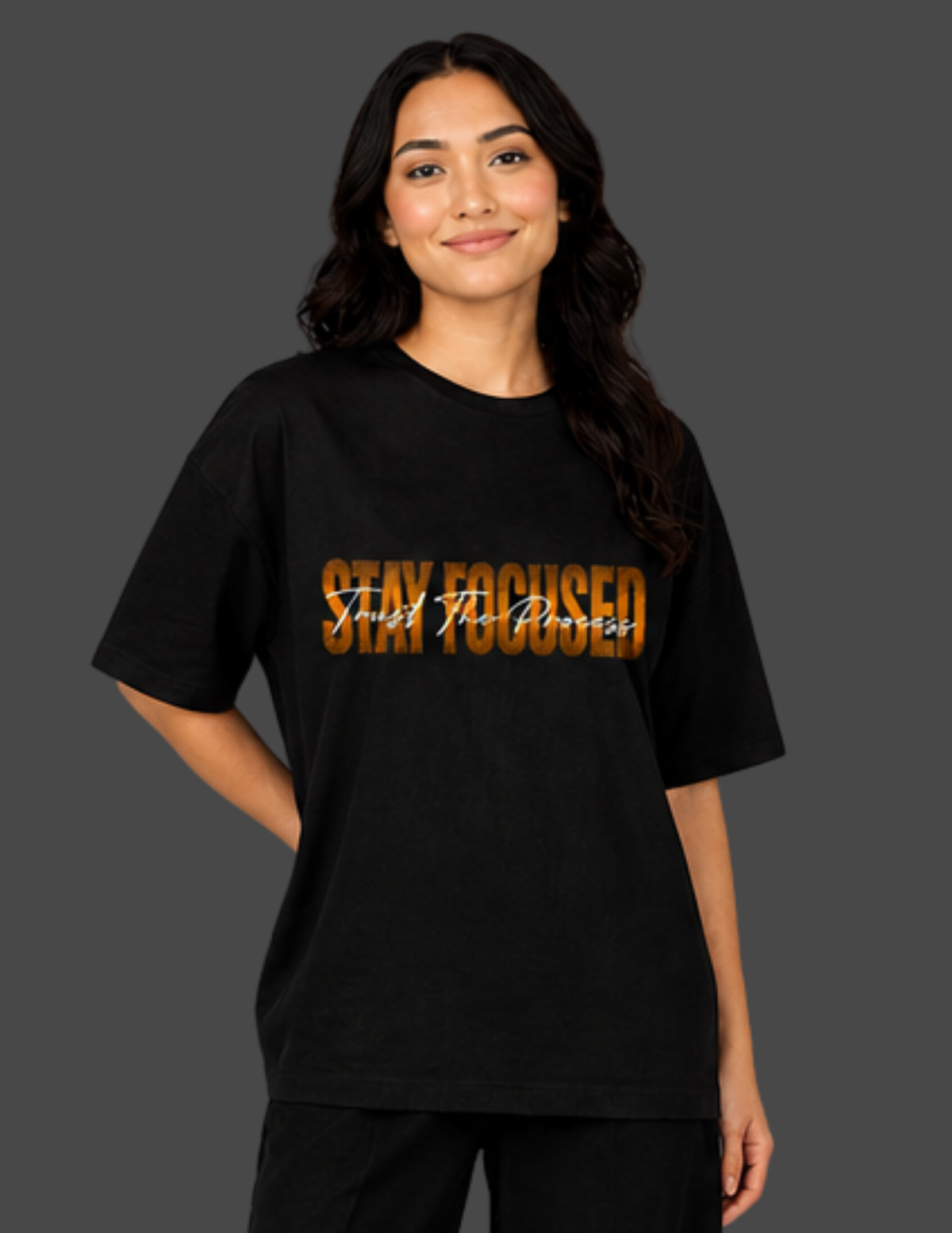 Person wearing a black t-shirt with 'Stay Focused' text on a dark background
