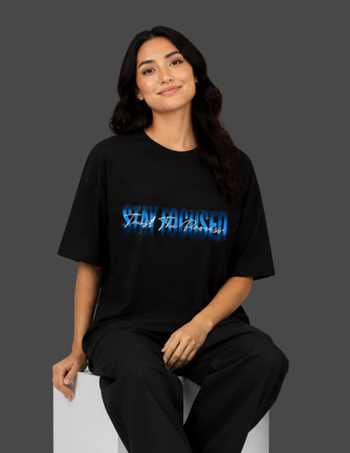 Person wearing a black t-shirt with blue text on a gray background
